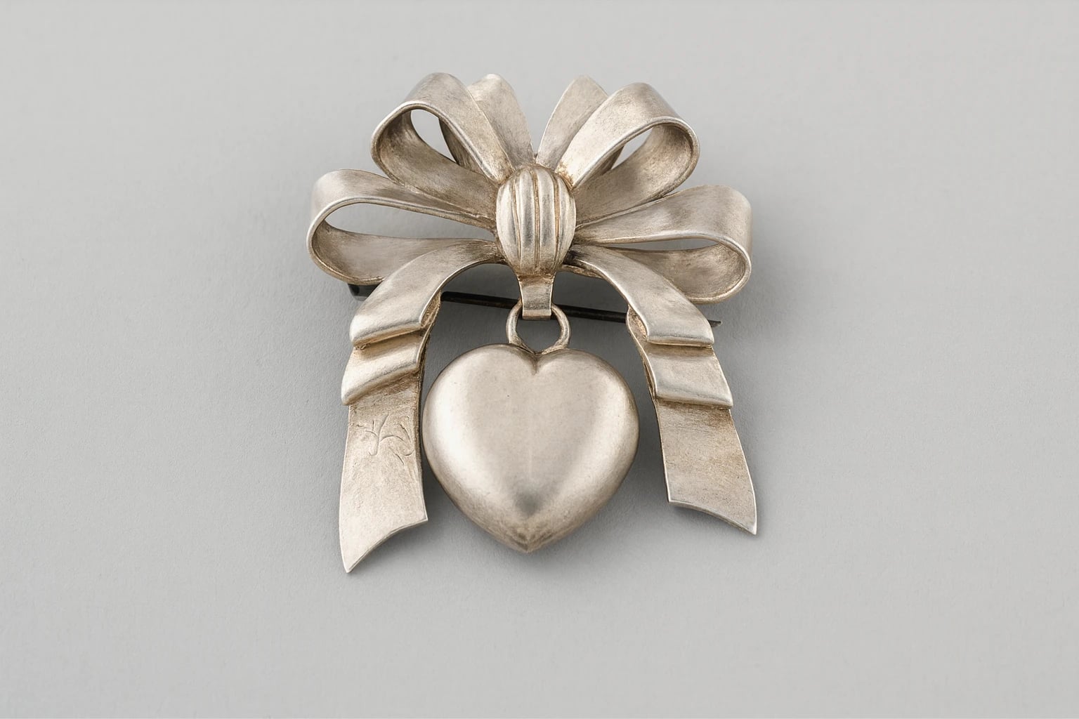 William Spratling Bow Brooch with a Dangling Heart